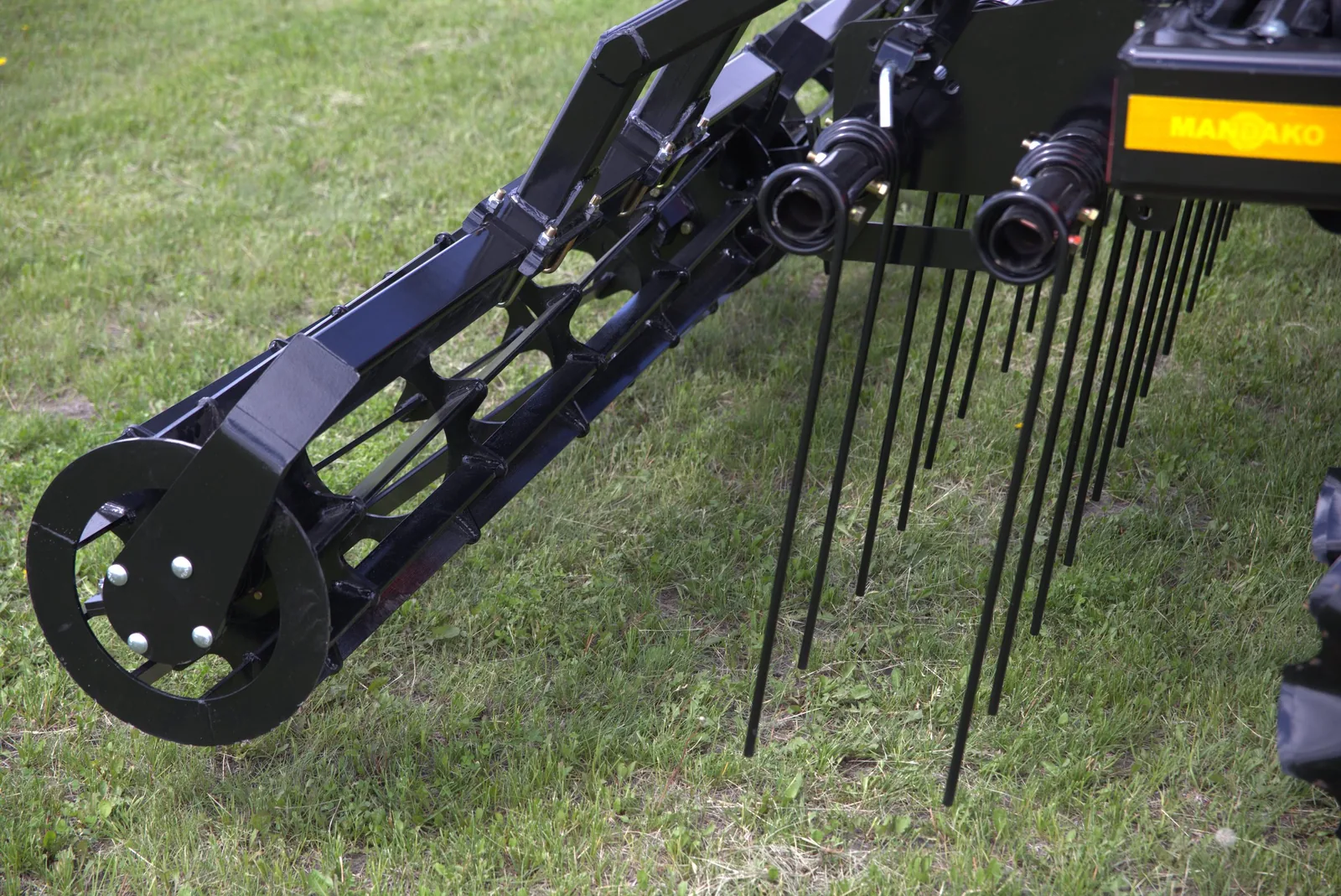 Close-up of Mandako Storm working tines and frame on green pasture