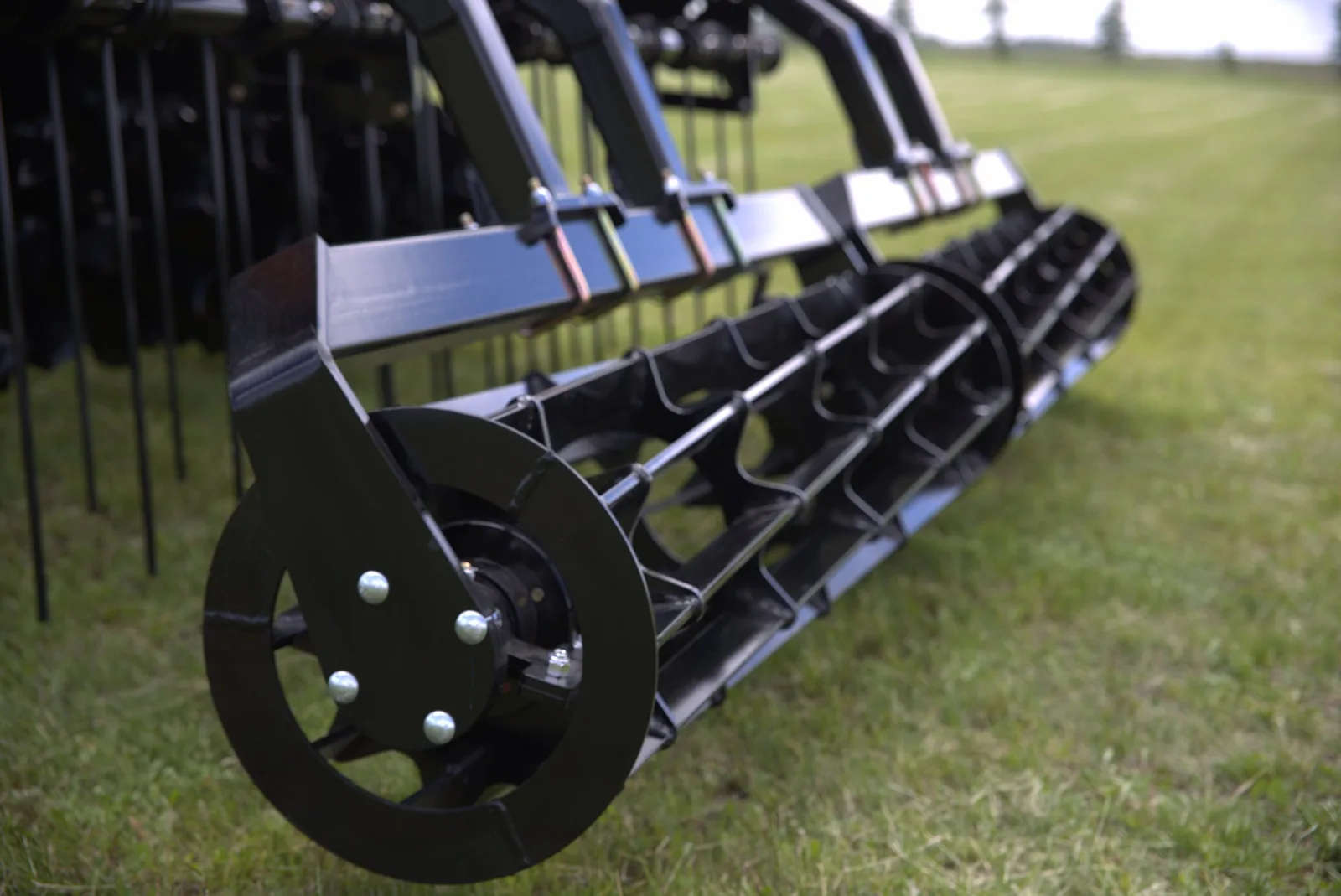 Close view of Mandako Storm packer wheels and frame in a field
